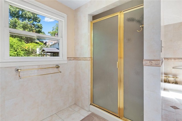 bathroom featuring tile patterned flooring and an enclosed shower