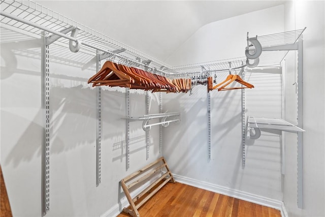 spacious closet with hardwood / wood-style floors and lofted ceiling