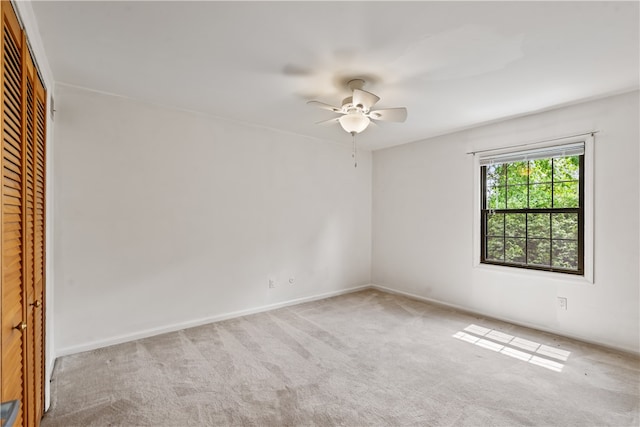 carpeted empty room with ceiling fan