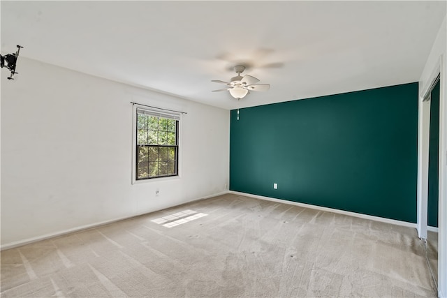 empty room with ceiling fan and carpet flooring