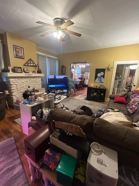 living room with wood-type flooring and ceiling fan