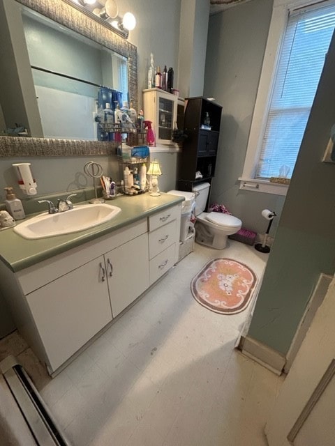 bathroom featuring tile flooring, vanity with extensive cabinet space, and toilet