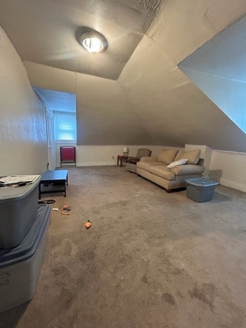 bonus room with vaulted ceiling and carpet