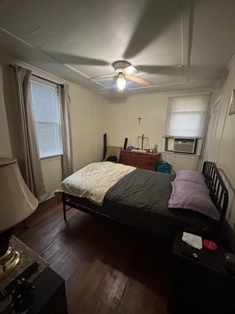 bedroom with ceiling fan and dark wood-type flooring