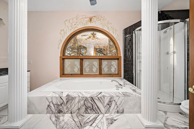 bathroom featuring tile flooring, ornate columns, toilet, and plus walk in shower