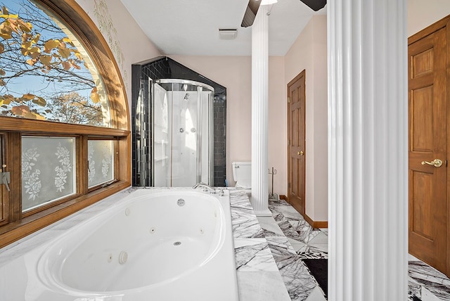 bathroom with tile floors, ornate columns, ceiling fan, and toilet