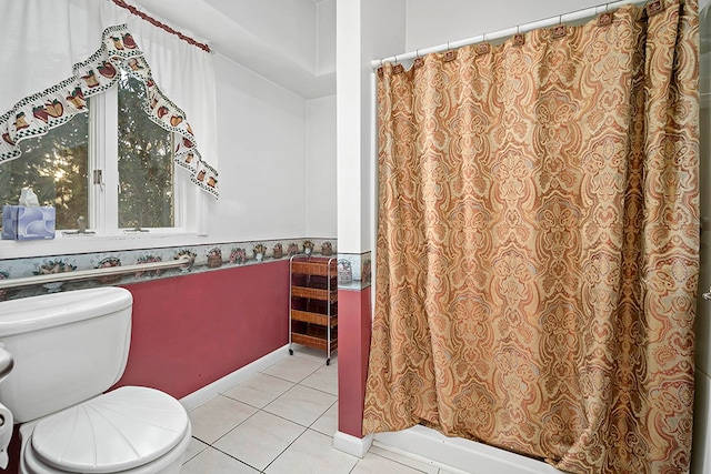 bathroom with tile flooring and toilet