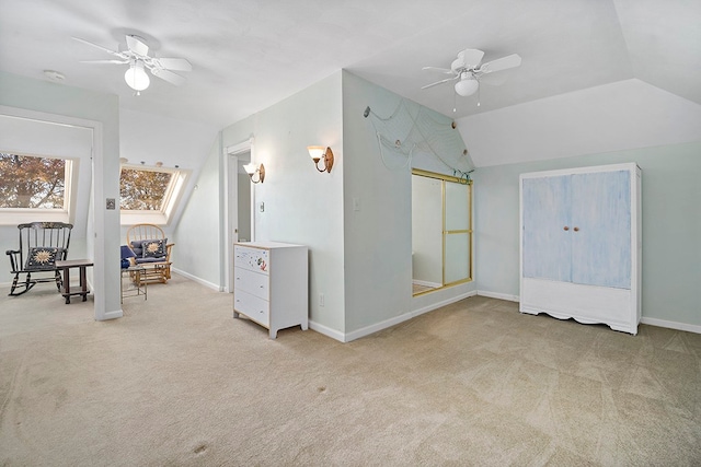 additional living space featuring ceiling fan, light colored carpet, and lofted ceiling