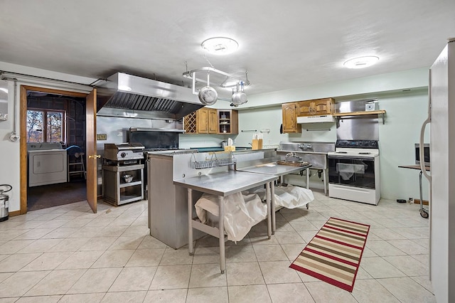 kitchen with light tile flooring, washer / dryer, white range with electric stovetop, and island exhaust hood