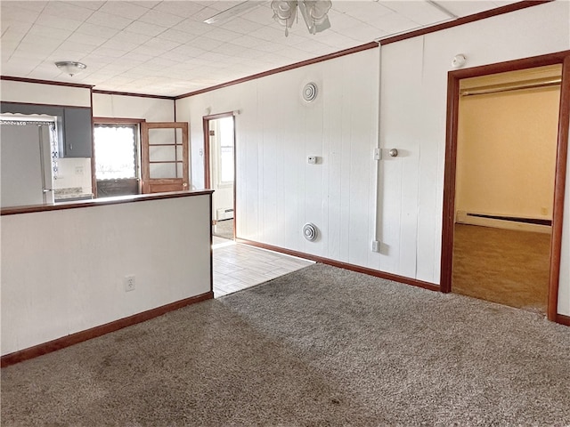 interior space with ceiling fan, a baseboard radiator, and ornamental molding