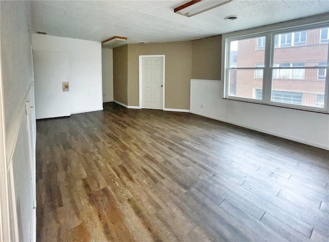 unfurnished room featuring dark wood-type flooring