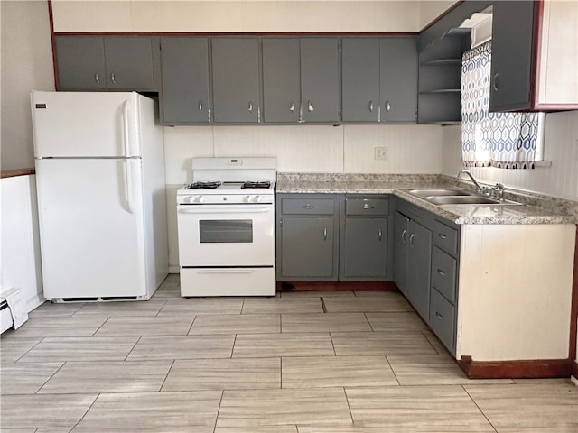 kitchen with sink, gray cabinets, and white appliances