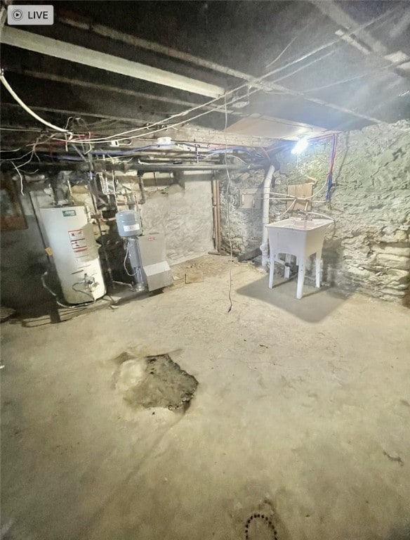 basement featuring water heater and sink