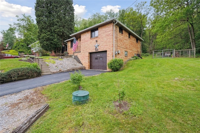 view of home's exterior with a garage and a yard