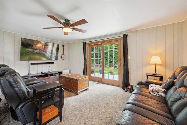 carpeted living room with ceiling fan