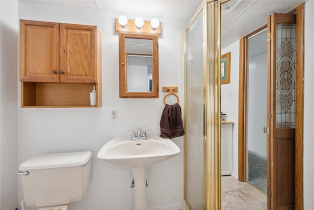 bathroom with a shower with door, tile flooring, and toilet