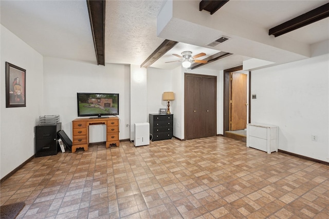 living room with beamed ceiling, ceiling fan, and light tile floors