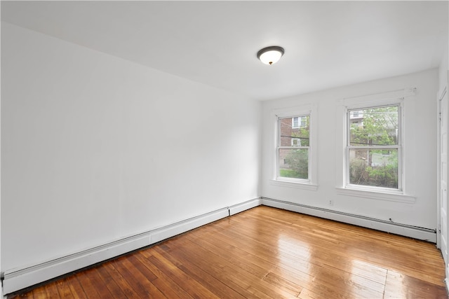 spare room with light hardwood / wood-style flooring and baseboard heating