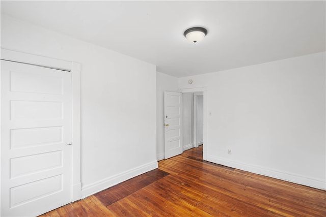 empty room with dark hardwood / wood-style floors