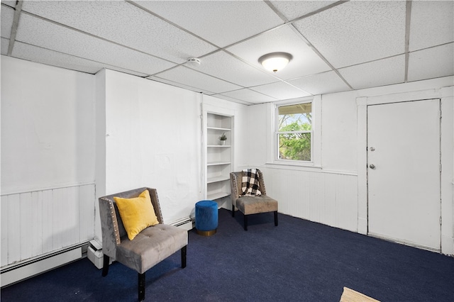 sitting room with a baseboard radiator, carpet flooring, and a paneled ceiling