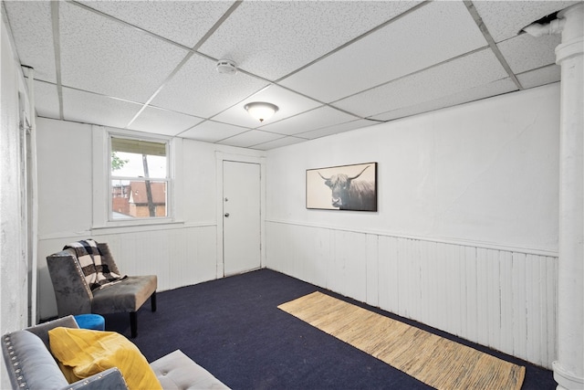 unfurnished room with carpet and a paneled ceiling