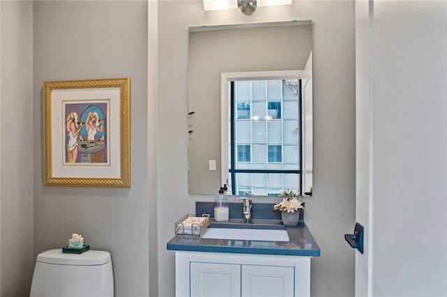 bathroom featuring vanity and toilet