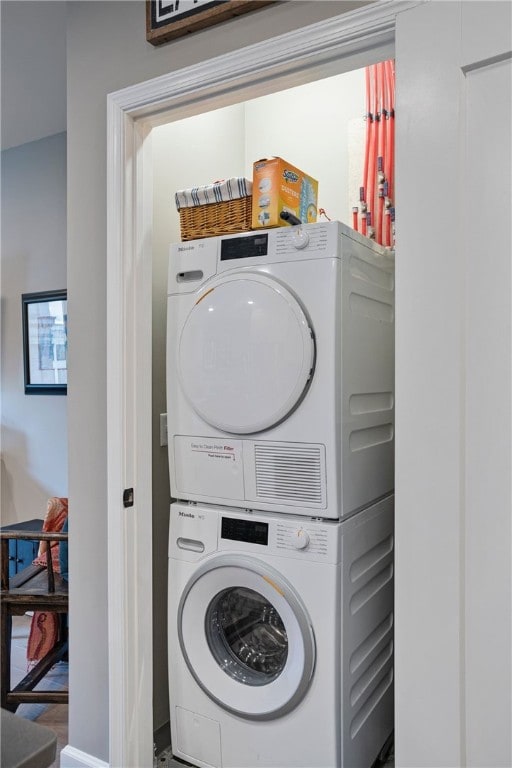 laundry area featuring stacked washer and dryer