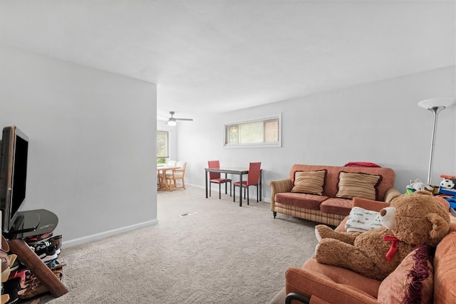 carpeted living room featuring ceiling fan