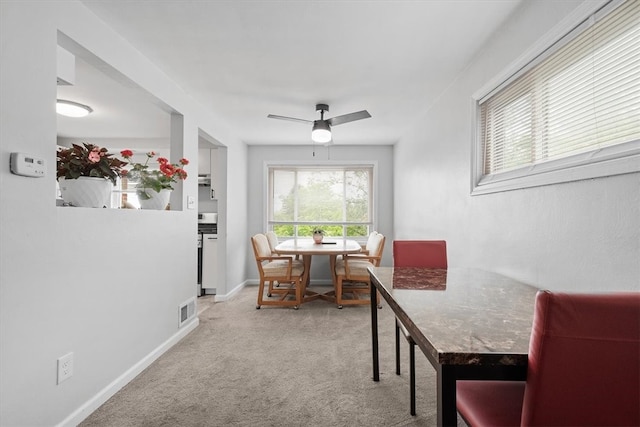 dining area featuring carpet and ceiling fan