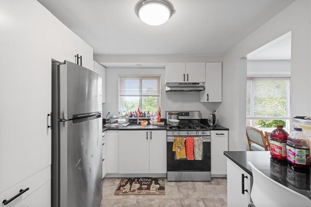 kitchen with light tile floors, white cabinets, and appliances with stainless steel finishes