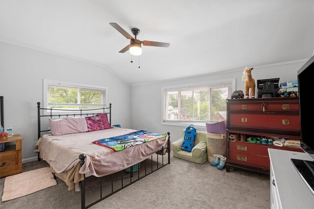 bedroom featuring ornamental molding, ceiling fan, vaulted ceiling, and light colored carpet