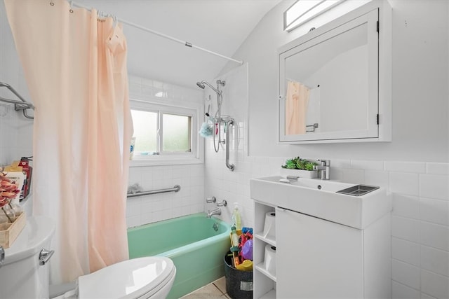 bathroom with tile flooring, tile walls, toilet, and shower / tub combo