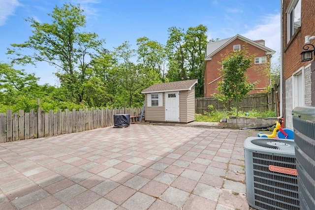 view of patio / terrace with a shed and central air condition unit