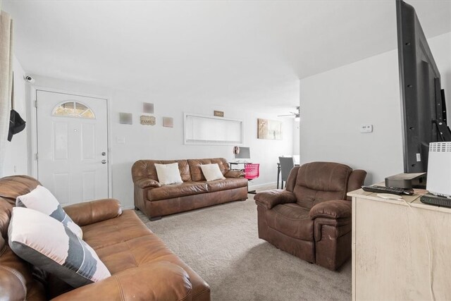 living room featuring carpet and ceiling fan