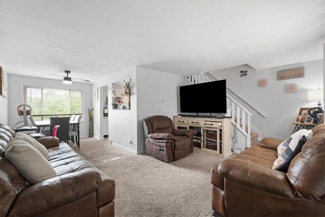 carpeted living room with ceiling fan