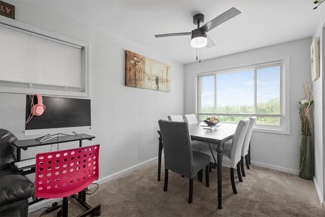 carpeted dining area featuring ceiling fan