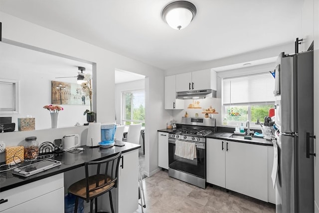 kitchen with ceiling fan, white cabinetry, appliances with stainless steel finishes, sink, and light tile floors