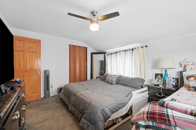 carpeted bedroom with vaulted ceiling and ceiling fan