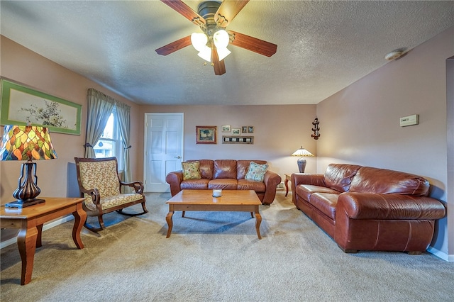 carpeted living room with ceiling fan and a textured ceiling