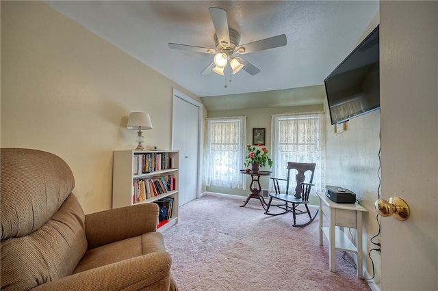 sitting room featuring carpet flooring and ceiling fan