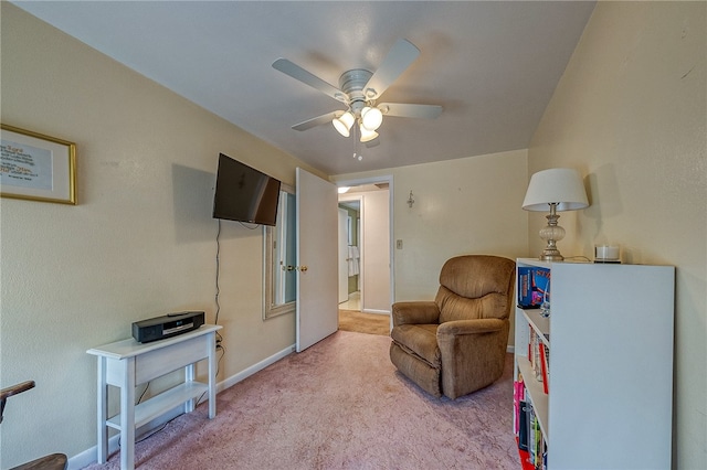 living area featuring ceiling fan and carpet flooring