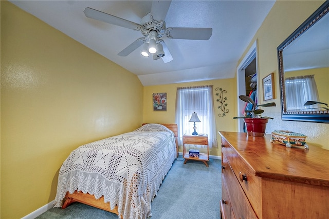 bedroom with vaulted ceiling, ceiling fan, and carpet floors