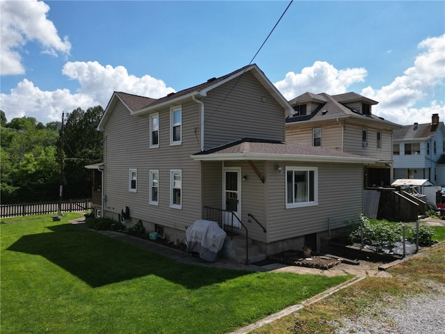 back of property featuring a lawn