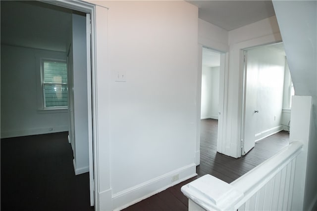 hallway with dark hardwood / wood-style floors