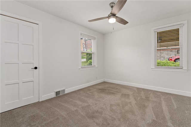 unfurnished bedroom featuring carpet, ceiling fan, and a closet