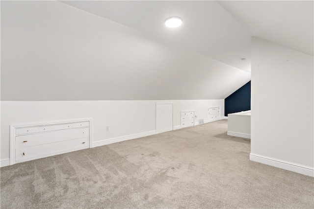 bonus room featuring lofted ceiling and carpet floors