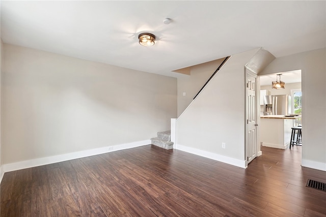 unfurnished living room with dark wood-type flooring