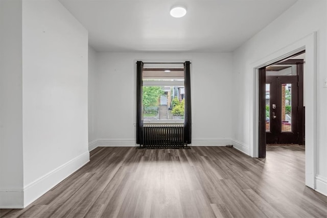 unfurnished room with hardwood / wood-style floors