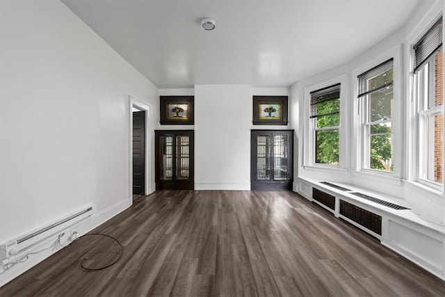 unfurnished living room featuring a baseboard heating unit, dark hardwood / wood-style floors, and radiator