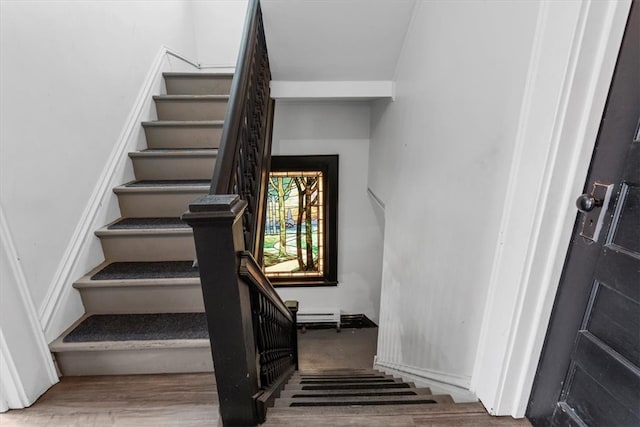 stairs featuring wood-type flooring